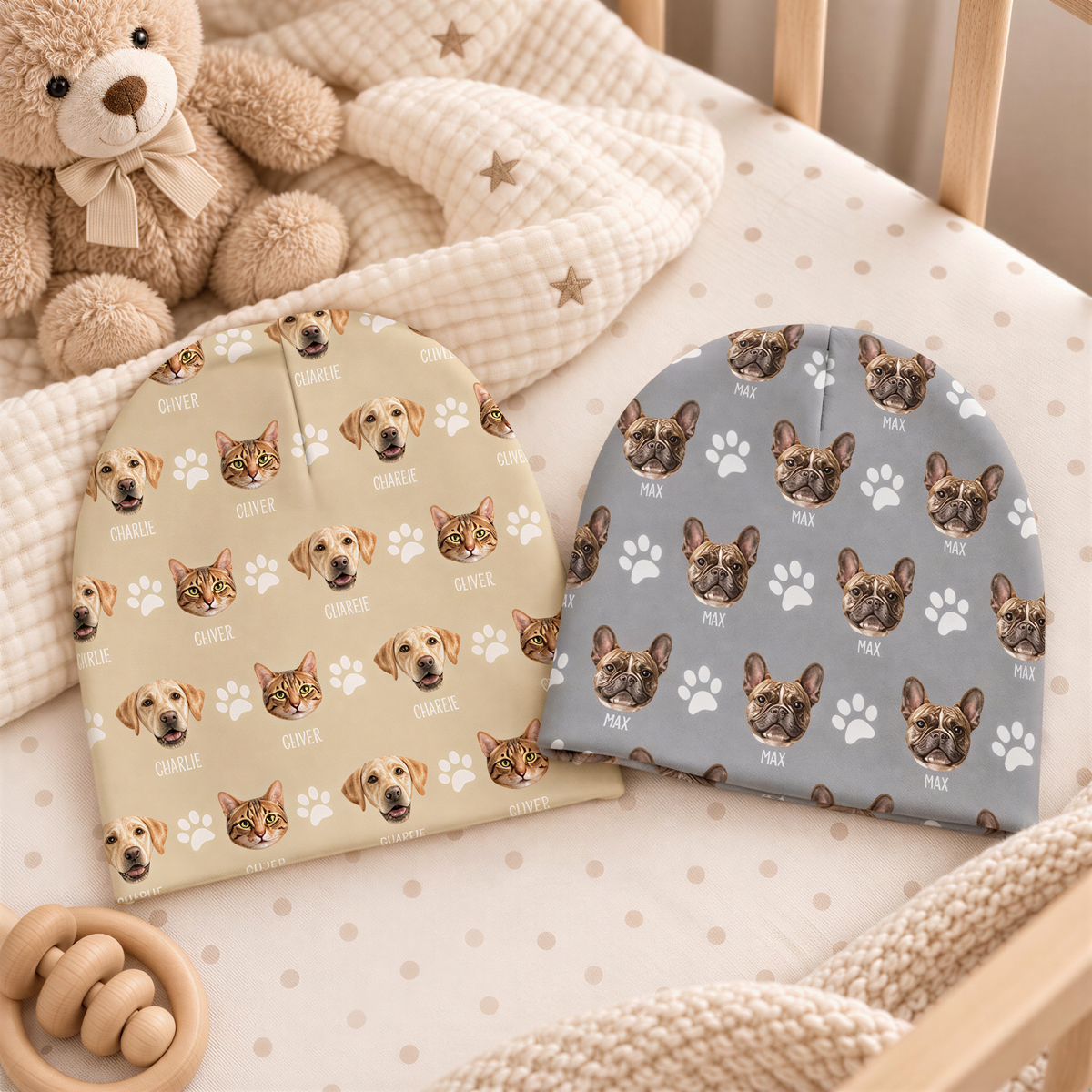 A teddy bear and two baby hats with dog faces are placed on a white bed with a wooden crib in the background.