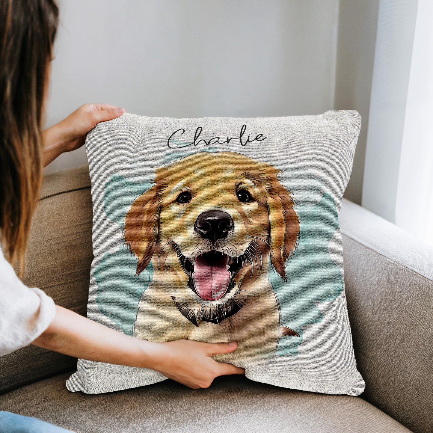 A custom woven pillow featuring a personalized pet portrait of a happy Golden Retriever named 'Charlie.' The design has a hand-drawn, artistic feel with a soft watercolor background, making it a perfect cozy and sentimental gift for dog lovers or pet owners.