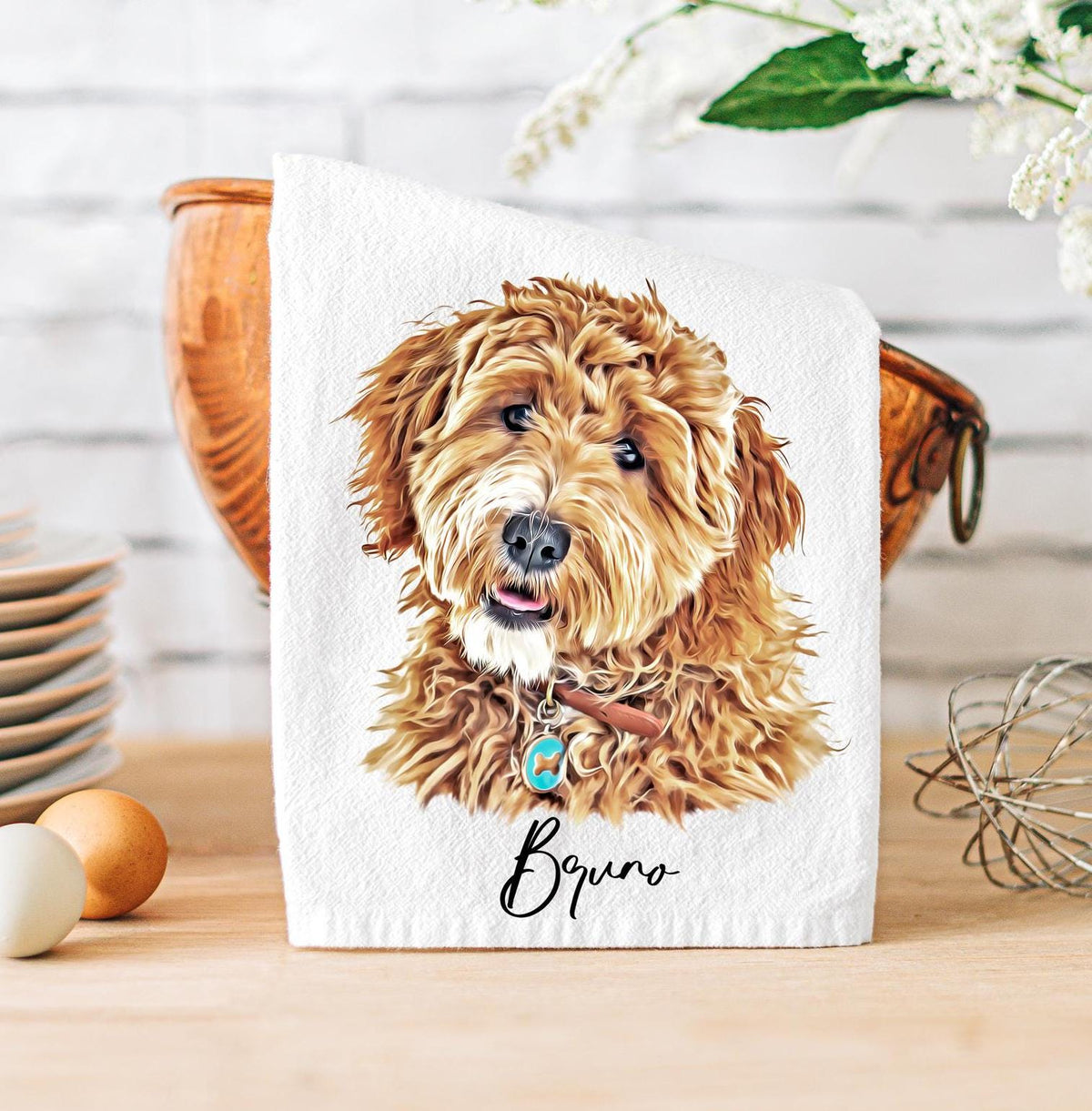 A white custom tea towel featuring a vibrant, lifelike digital illustration of a fluffy brown dog named 'Bruno.' The dog's portrait is detailed, showcasing its expressive eyes, soft fur, and a collar with a blue tag. Personalized pet-themed kitchen decor, perfect for dog lovers.