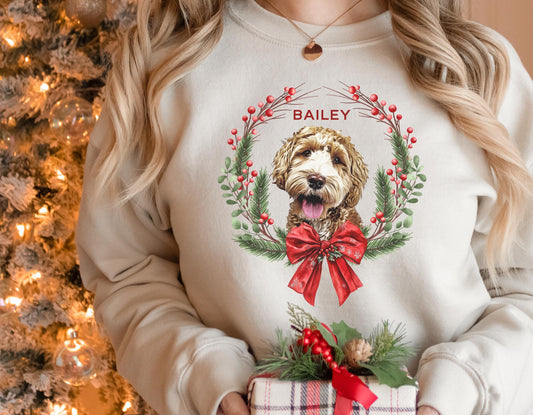 Personalized Christmas sweatshirt featuring a custom dog portrait inside a festive wreath with red bow and berries — cozy holiday gift for pet lovers.