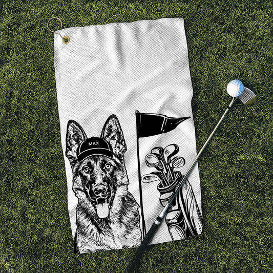Personalized golf towel featuring a custom black and white dog illustration with a golf cap labeled 'Max' and golf clubs with a flag design, displayed on grass with a golf club and ball, perfect for pet lover gifts and golf enthusiasts.