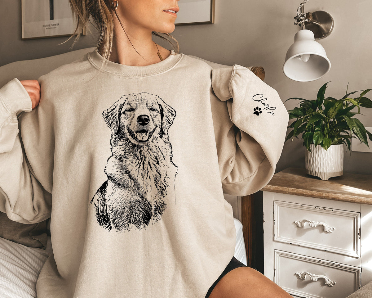 Custom pet sweatshirt featuring your pet's portrait on the front and their name with a paw print on the sleeve. This personalized crewneck is perfect for dog and cat lovers, making a cozy and heartfelt gift for any occasion!
