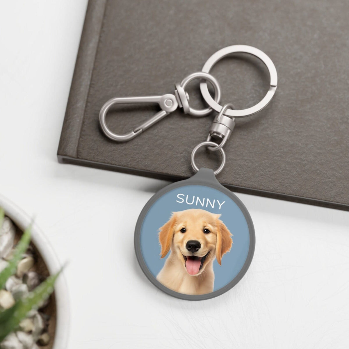 Custom keychain featuring a smiling Golden Retriever named 'Sunny' on a blue background, attached to a metal ring and clip. Ideal personalized accessory or pet memorial gift.