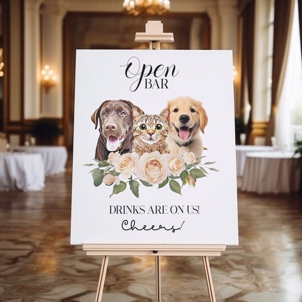 Custom Pet Open Bar Sign featuring personalized pet portraits of a dog and a cat, accented with floral designs, perfect for weddings or events. The sign reads 'Open Bar - Drinks Are On Us! Cheers!' in elegant typography.