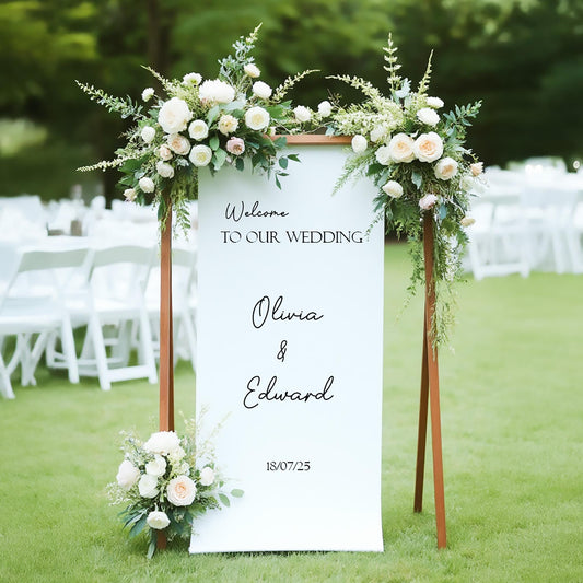 Elegant outdoor wedding welcome sign with white and blush floral arrangements, rustic wooden frame, personalized with names Olivia and Edward and wedding date 18/07/25, perfect for garden or outdoor wedding décor.